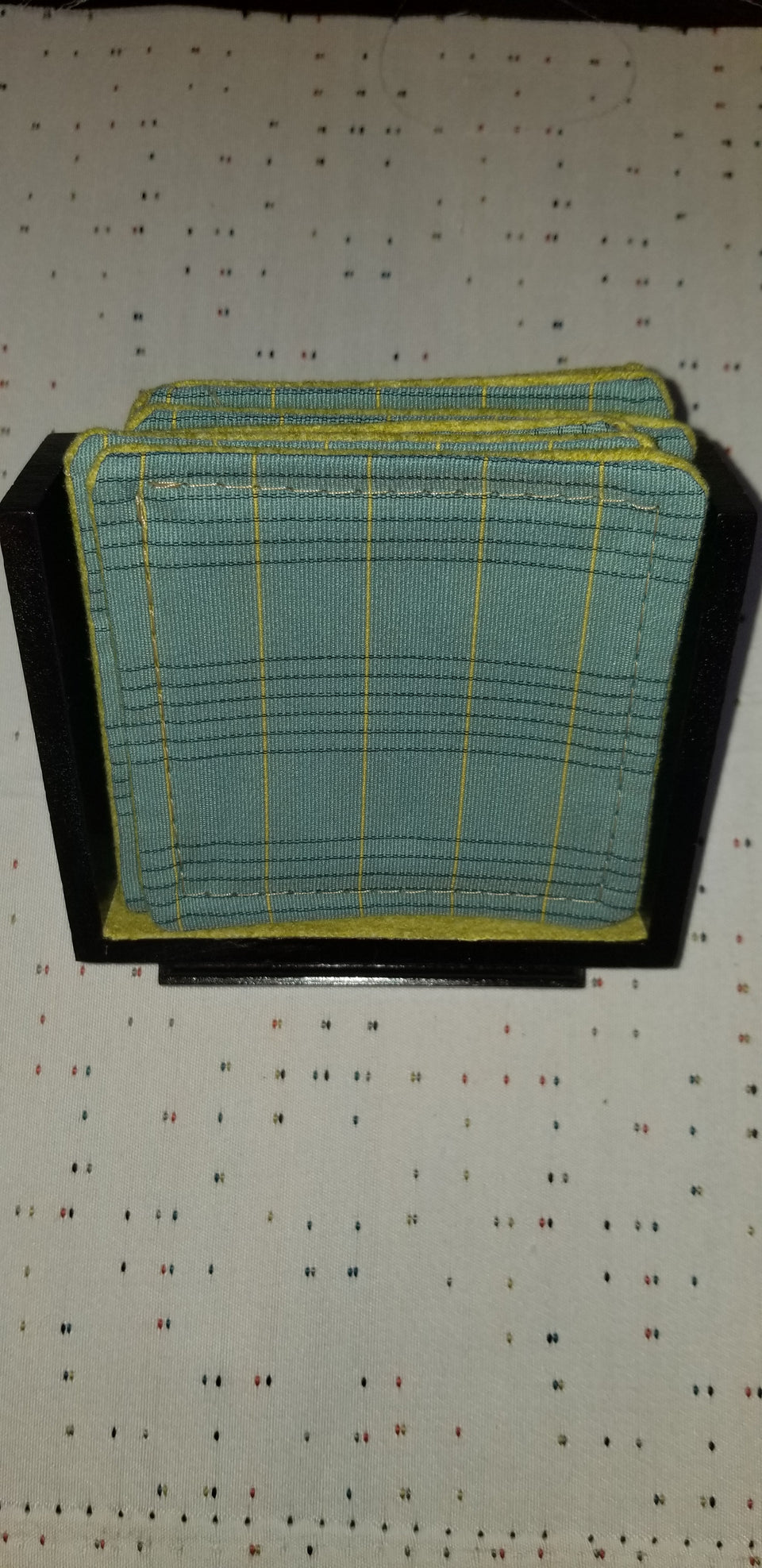 modern walnut pedestal coaster holder with turquoise and lime green plaid coasters front