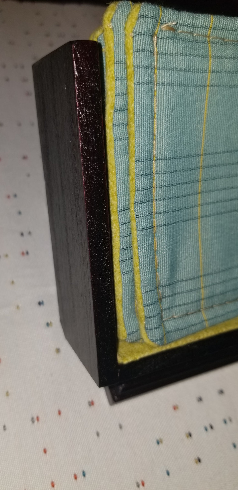 modern walnut pedestal coaster holder with turquoise and lime green plaid coasters detail view