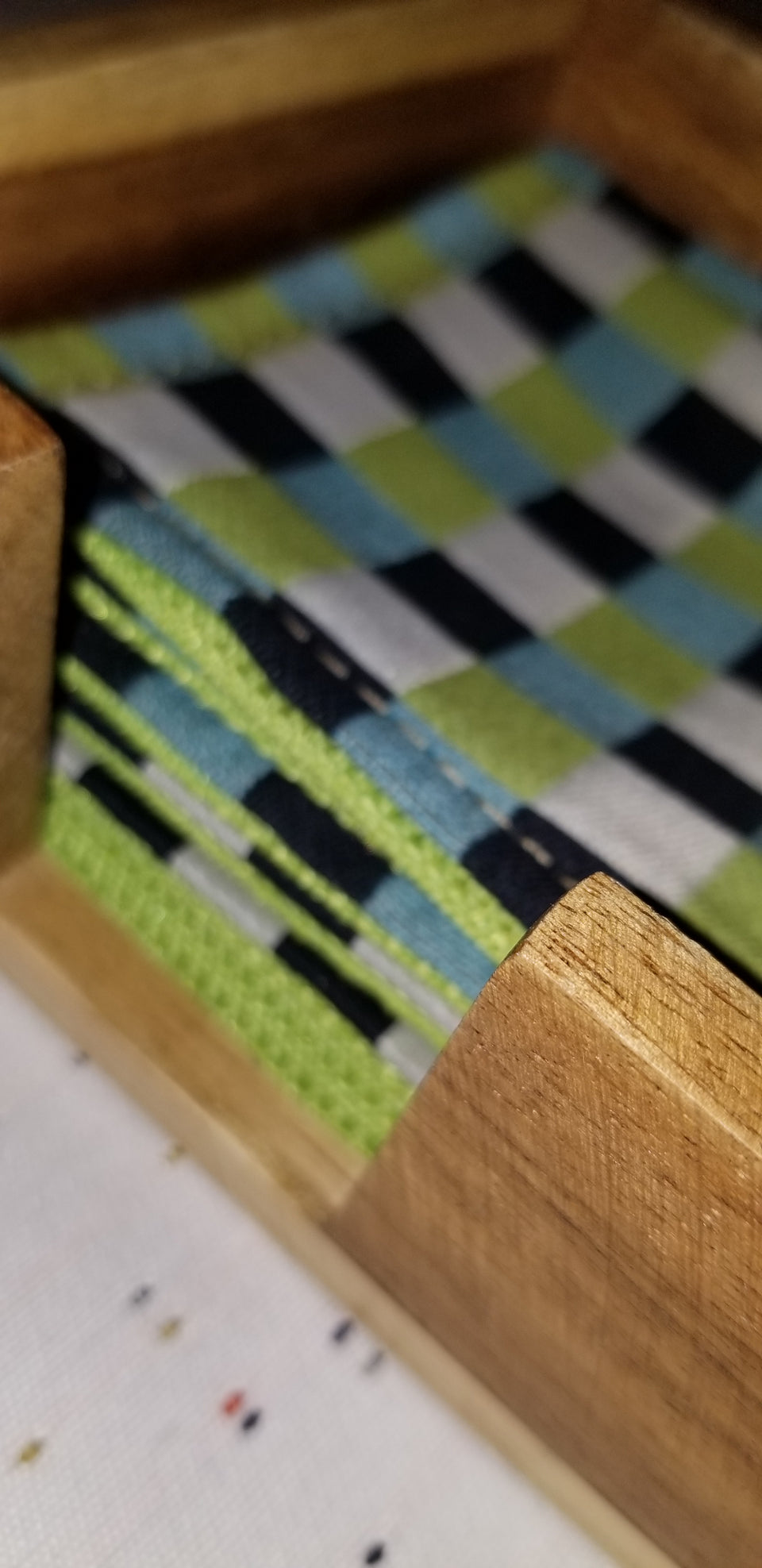 Modern square acacia wood coaster holder with black, white, lime green, and turquoise gingham check coaster.