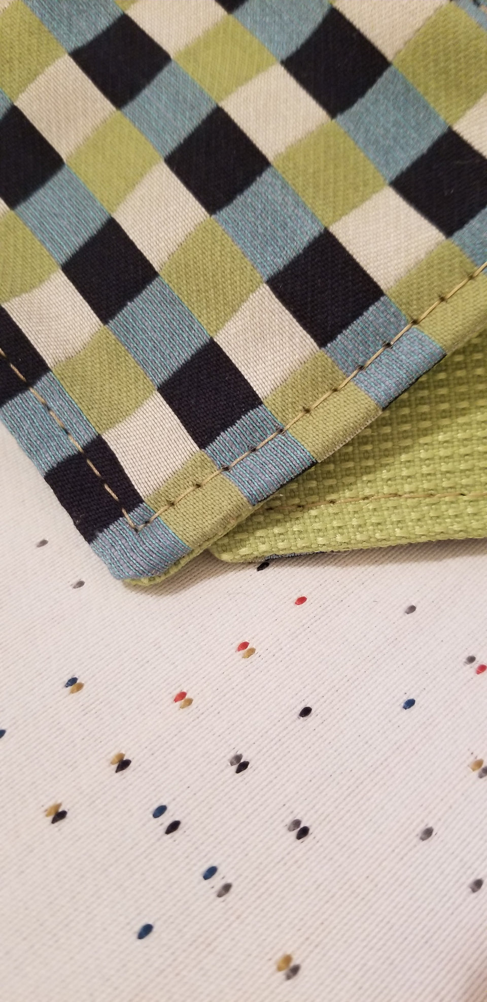 Chuck black, white, lime green, and turquoise gingham check patterned coasters detail view.