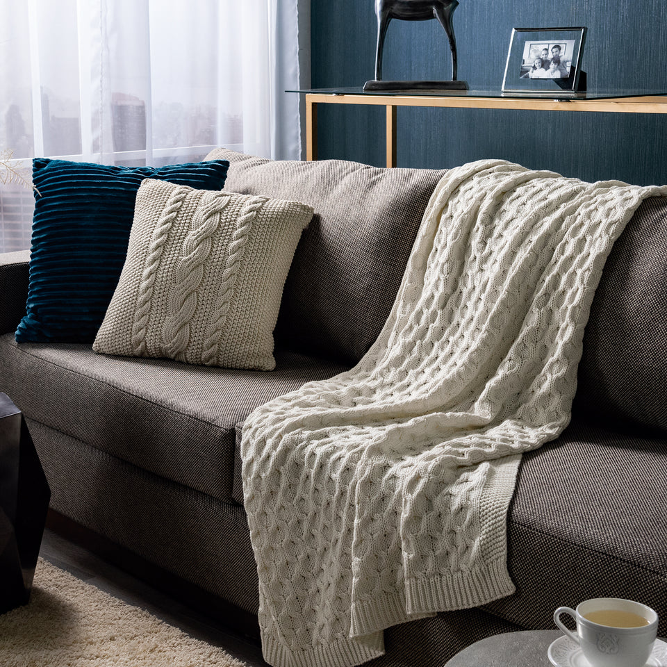ivory colored cable knit throw cover in living room setting
