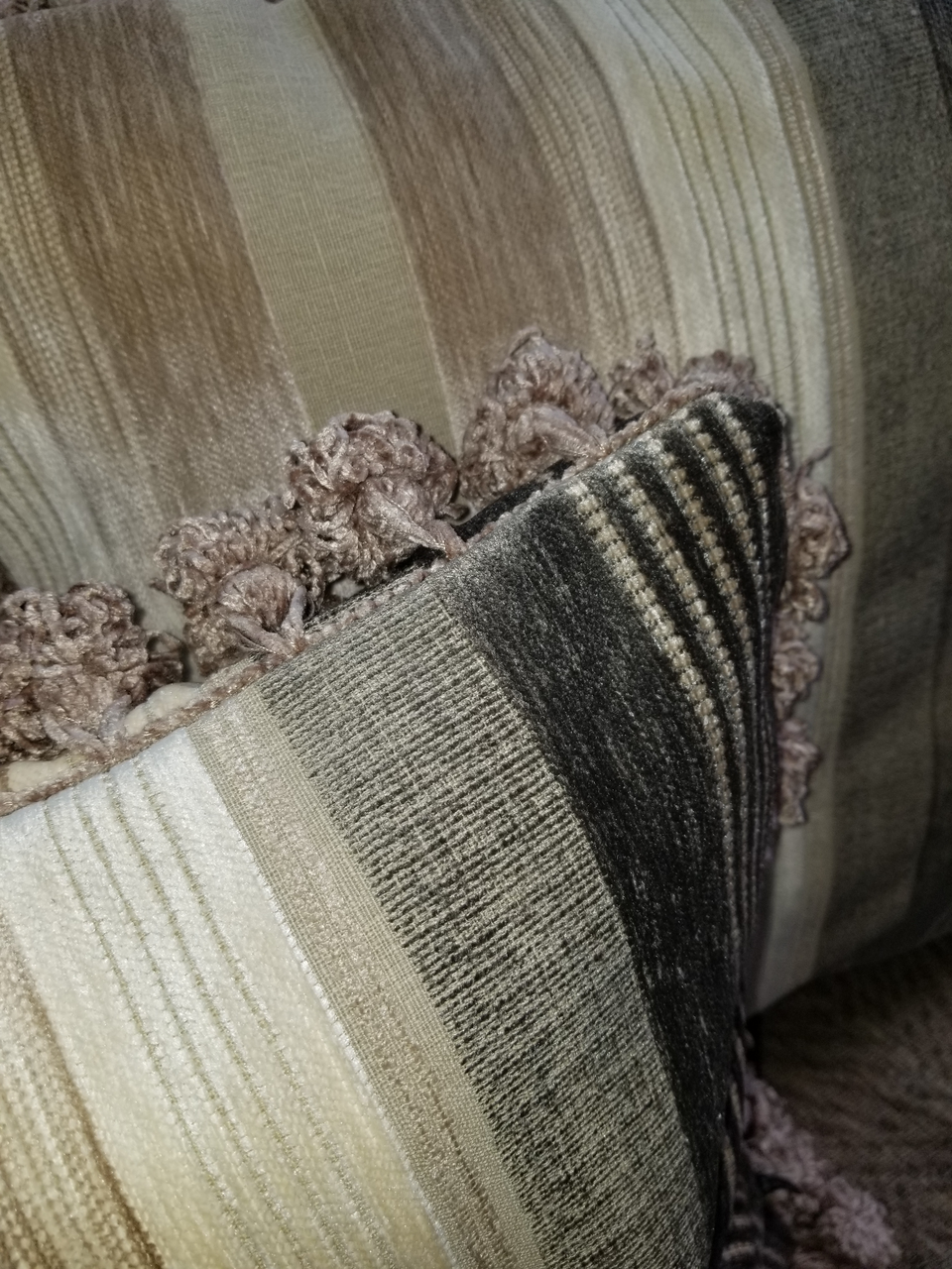 taupe and ivory velour stripe pillow cover with velour pom pom fringe trim closeup