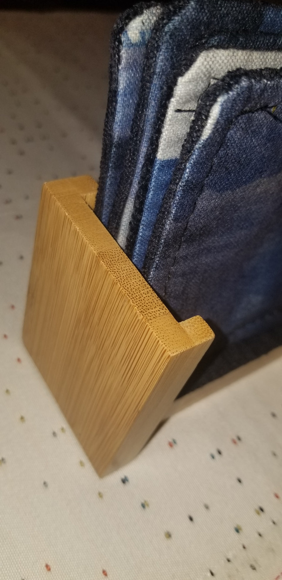 Modern bamboo upright coaster holder with blue velour lining with matching Chase coasters side detail.