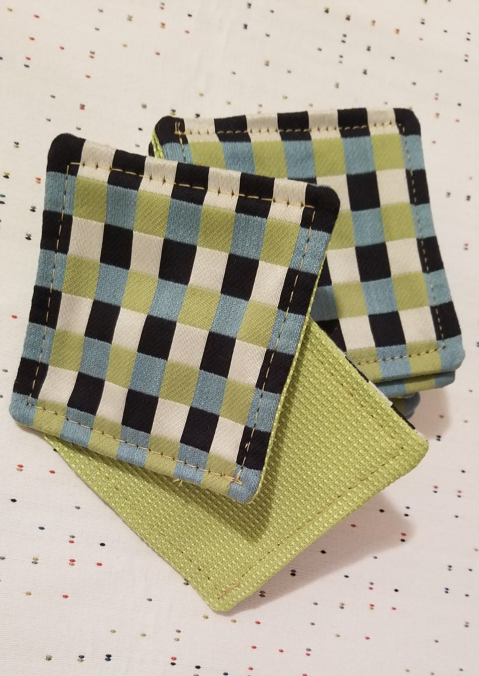 Chuck black, white, lime green, and turquoise gingham check patterned coasters front back detail.