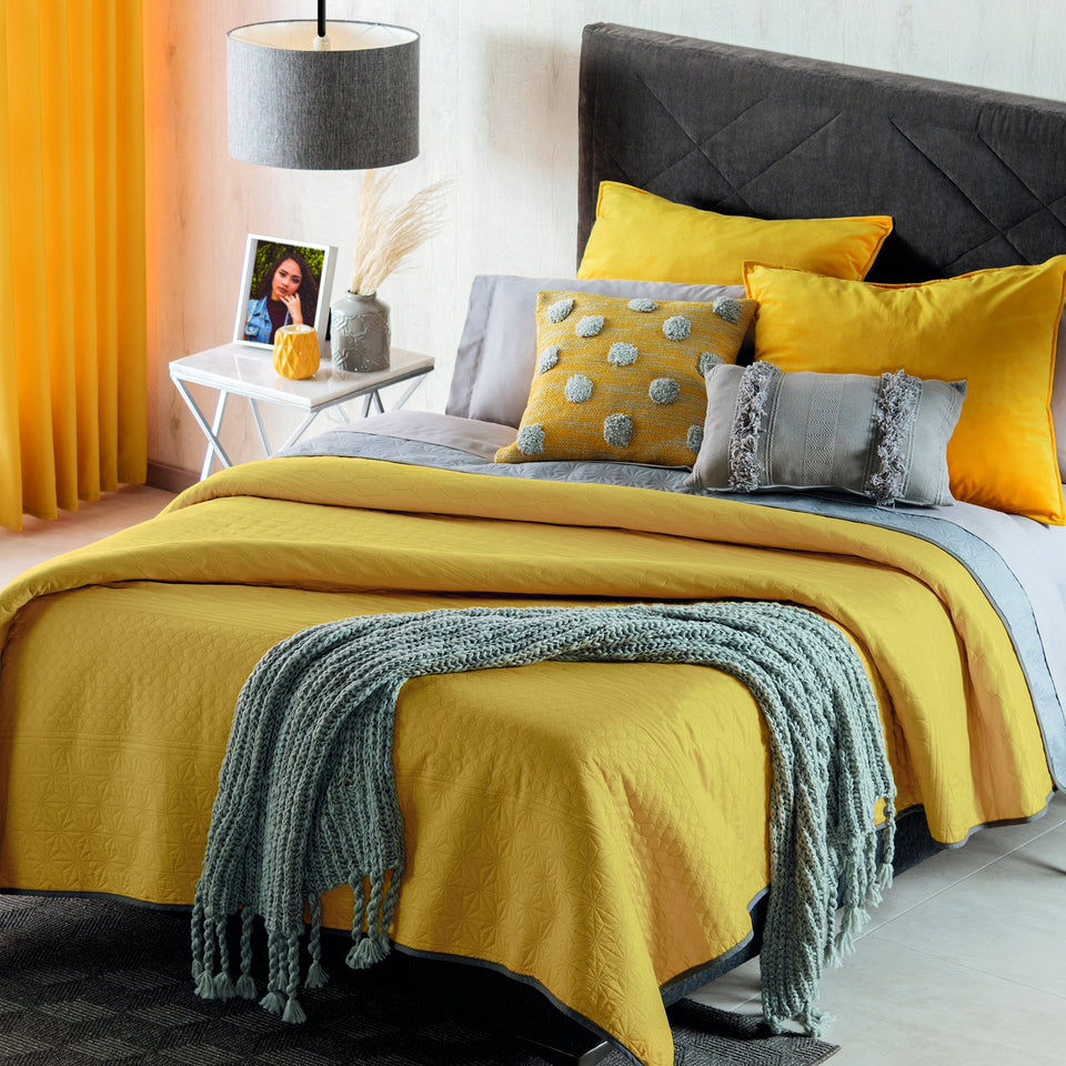 modern bedding set with gray and yellow decorative throw pillows showing gray throw blanket