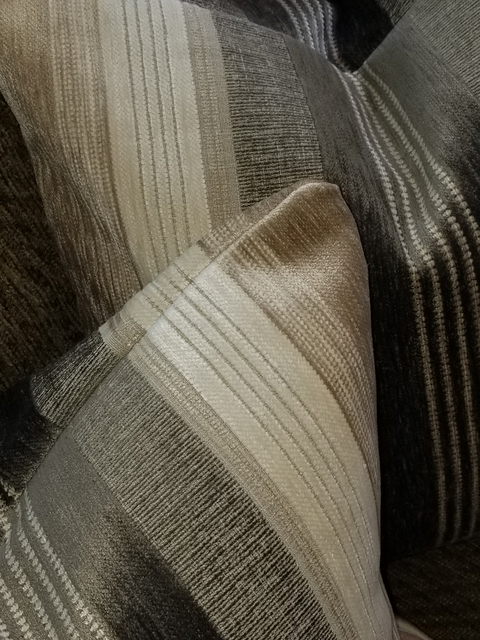 taupe and ivory velour stripe pillow covers on brown couch with taupe throw cover top view detail